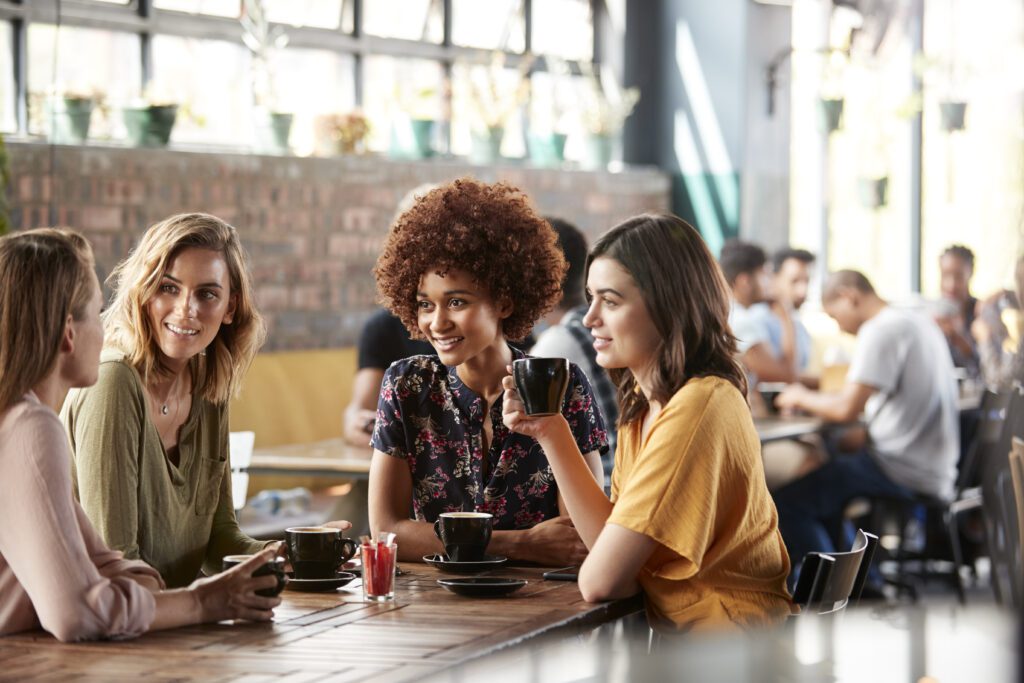 Young women networking in a local coffee shop.